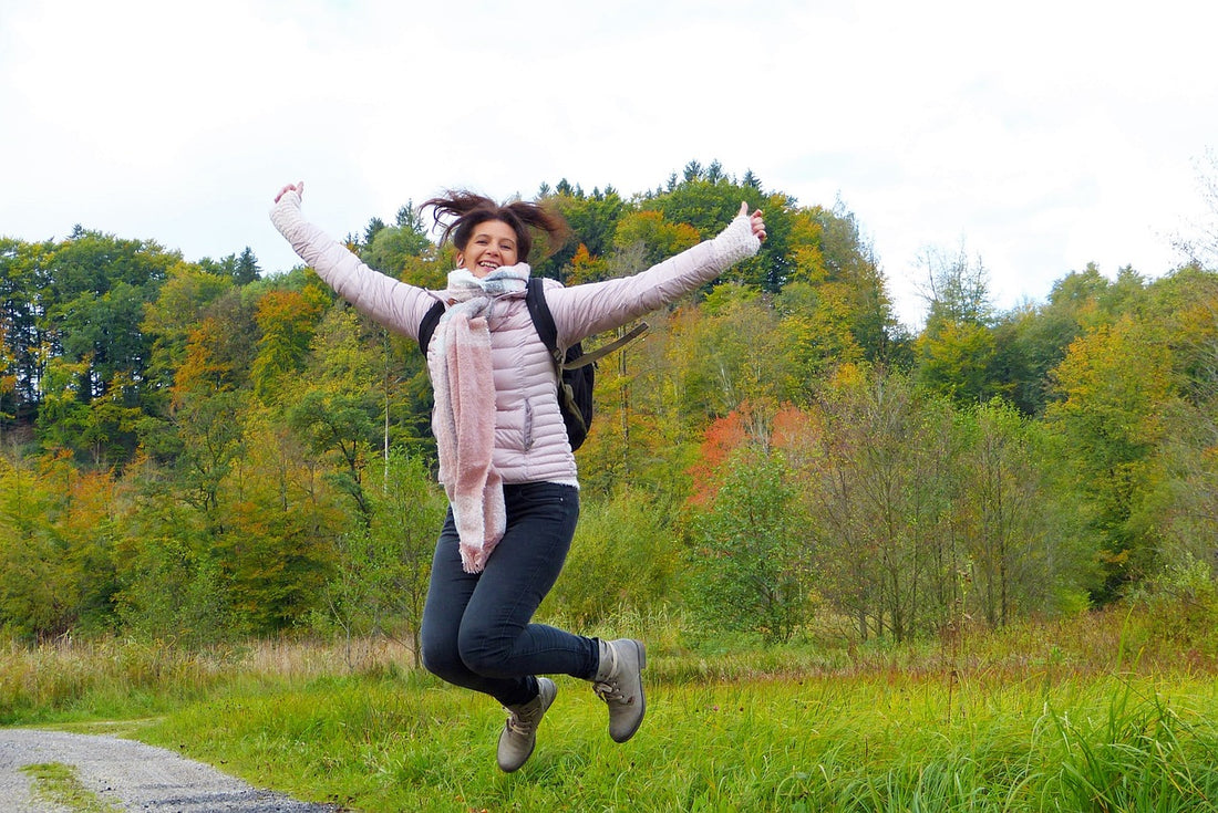 Woman with a positive mindset jumping into the air after taking Natural Stacks Serotonin Brain Food Supplements.